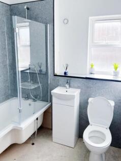 Bright modern bathroom with a combined bath and...