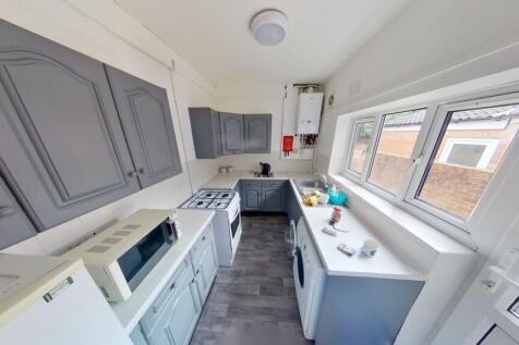 Bright and modern kitchen featuring ample count...