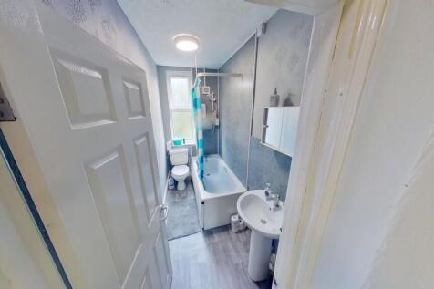 Bright and clean bathroom featuring modern fixt...