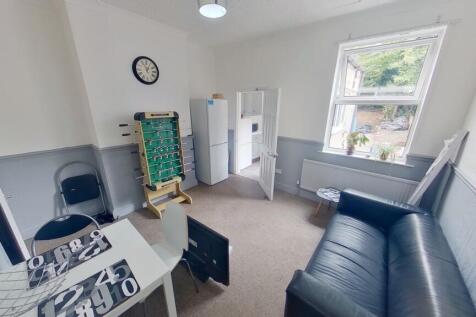 A clean and well-lit small room featuring a sin...