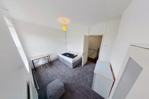 Bright and tidy bedroom featuring a large windo...