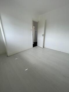 A clean, empty room with white walls and light ...