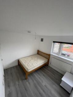 A neat and bright double bedroom featuring a wo...