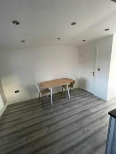 A minimalistic communal workspace featuring a s...