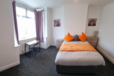 A bright and inviting double bedroom featuring ...