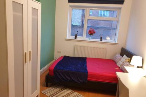 This inviting double bedroom features a cozy la...