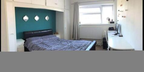 This cozy double bedroom features a comfortable...