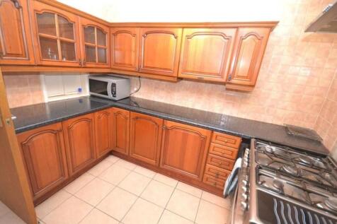 This charming kitchen boasts ample wooden cabin...