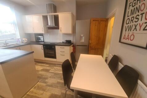A bright and modern kitchen featuring ample nat...
