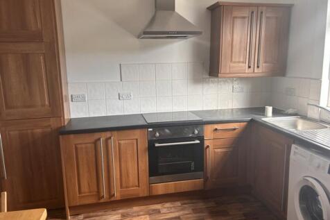 This inviting kitchen features ample wooden cab...