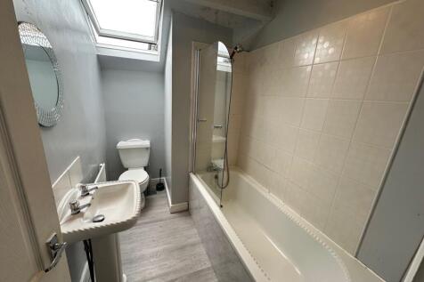 A bright and spacious bathroom suite featuring ...