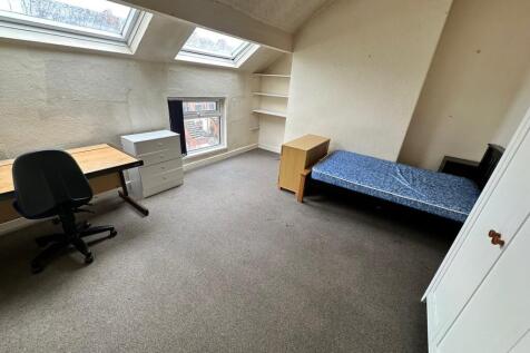Spacious double bedroom featuring large windows...