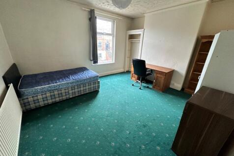 Spacious double bedroom featuring a comfortable...