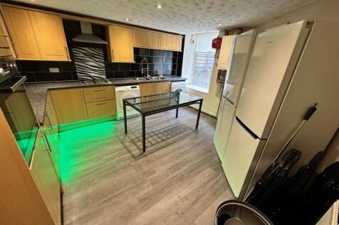 Modern kitchen featuring sleek cabinetry, ample...