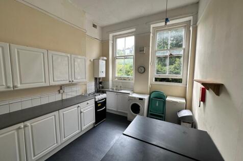 A spacious and functional kitchenette with ampl...