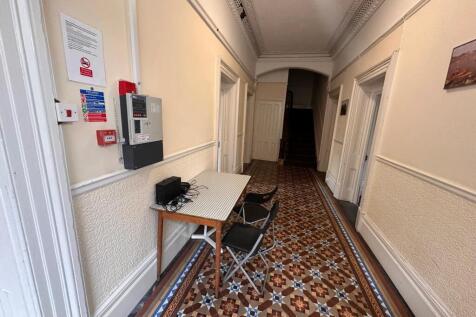 Bright, period hallway with decorative tiled fl...