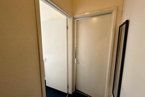 A tidy and well-maintained hallway leading to v...