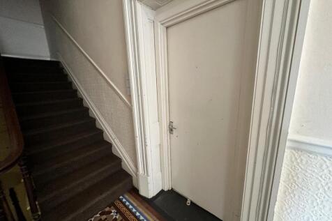 A well-maintained hallway with charming archite...