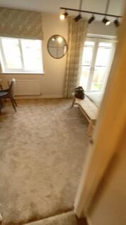 This inviting living room features large window...