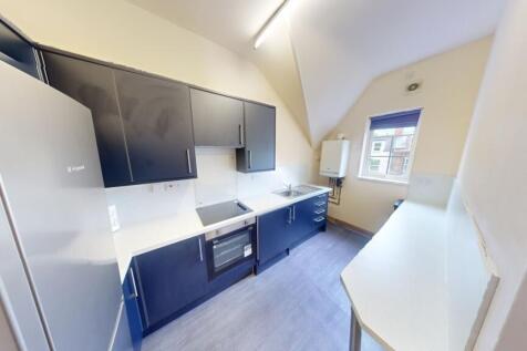 Bright and modern kitchen featuring sleek cabin...