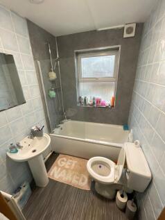 A bright and tidy bathroom featuring a full bat...