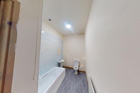 A clean and modern bathroom featuring a white b...