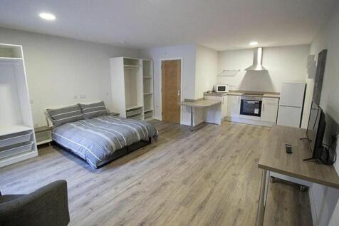 This spacious double bedroom features a comfort...