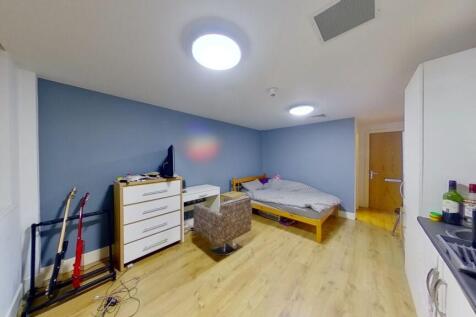 A neat and cozy single bedroom featuring a sing...