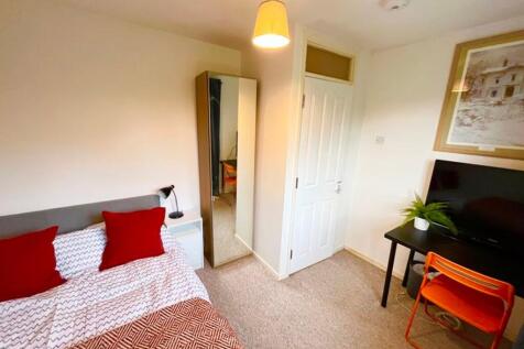 This cozy double bedroom features a comfortable...