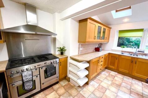 Spacious and well-equipped kitchen featuring am...