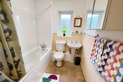 This modern bathroom features a clean design wi...