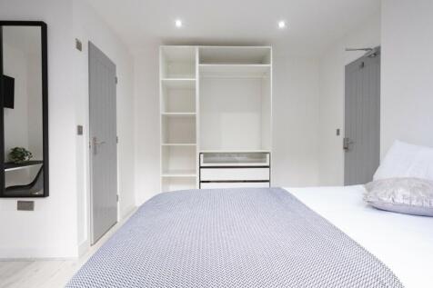 A bright and inviting double bedroom featuring ...