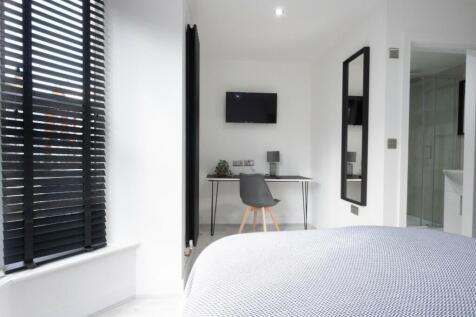 A stylish and well-lit double bedroom featuring...