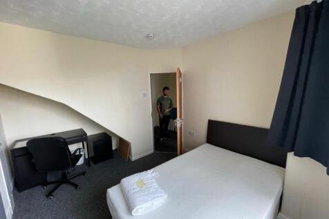 Cozy double bedroom featuring a comfortable bed...