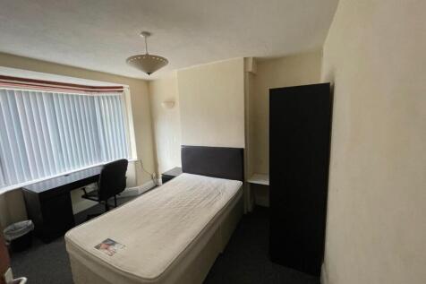 Bright and cozy single bedroom featuring a comf...