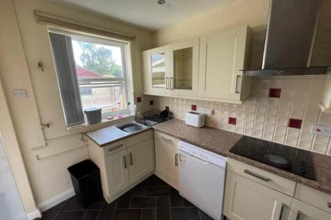 A well-equipped kitchen featuring modern cabine...