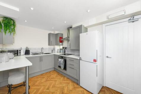 Modern kitchen featuring sleek cabinetry and am...