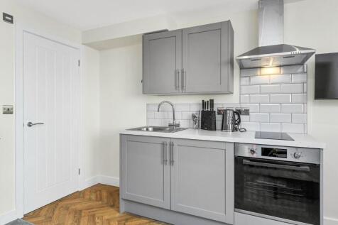 Modern kitchen featuring a sleek design with am...
