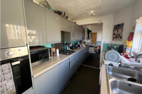 A spacious and modern kitchen with ample storag...