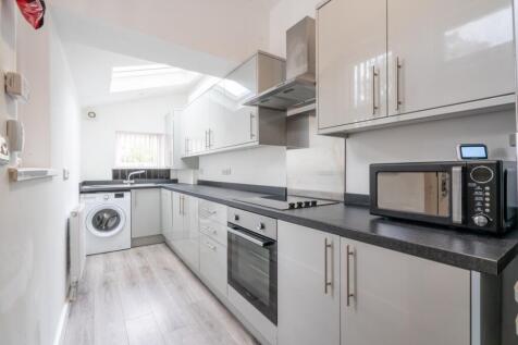 Bright and modern kitchen featuring sleek grey ...