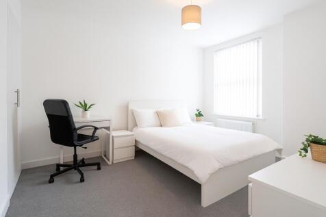 A bright and modern double bedroom featuring a ...