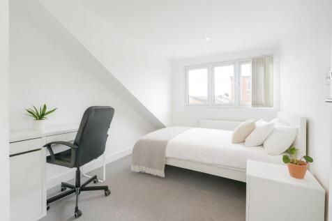 A bright and clean double bedroom featuring a c...