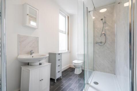Bright and modern bathroom featuring a spacious...
