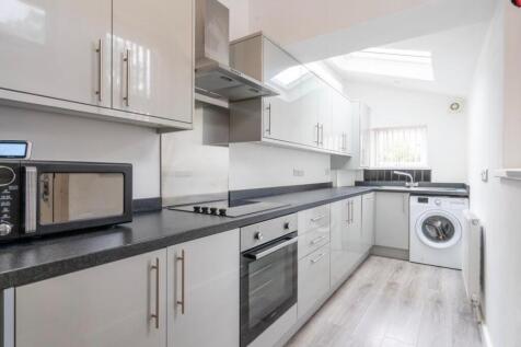 Bright and modern kitchen with sleek grey cabin...