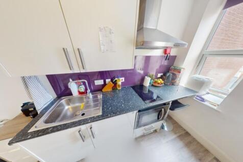 Bright and modern kitchen featuring sleek cabin...