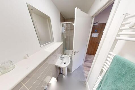 A modern bathroom featuring a sleek shower, cle...