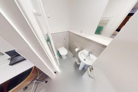 A modern bathroom featuring clean lines and a m...