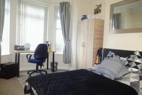 A stylish and well-lit double bedroom featuring...