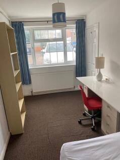 A bright and tidy double bedroom featuring larg...
