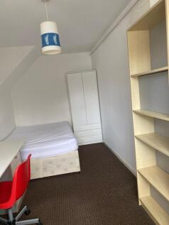 A bright and tidy double bedroom featuring a co...